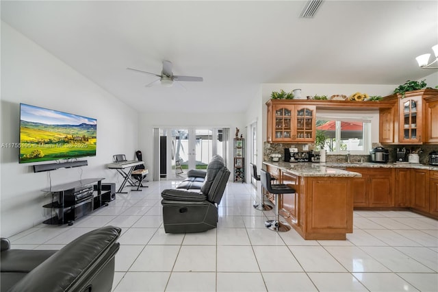 kitchen featuring a healthy amount of sunlight, open floor plan, brown cabinets, and french doors