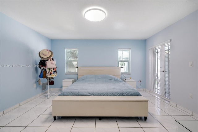 bedroom with light tile patterned floors