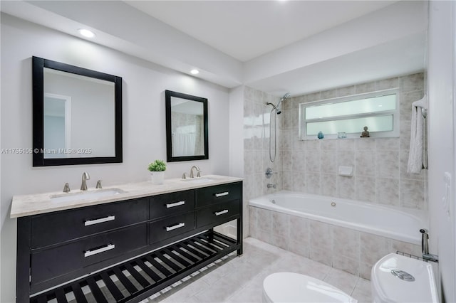 full bathroom featuring tile patterned flooring, a sink, tiled shower / bath combo, and toilet