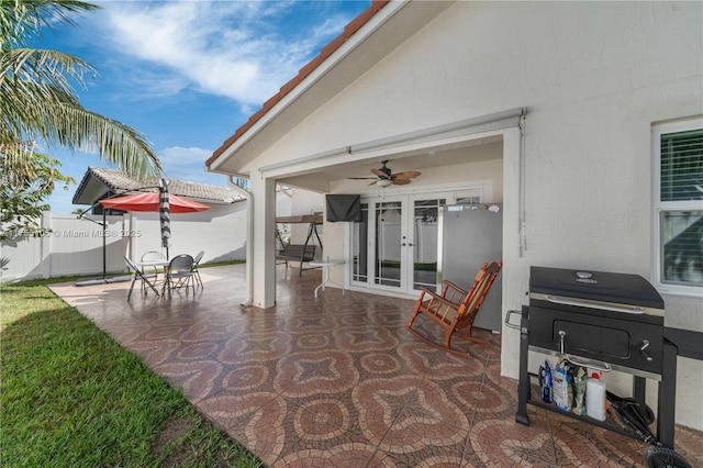 view of patio featuring french doors and fence