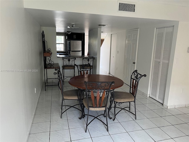 dining room featuring visible vents, baseboards, and light tile patterned flooring