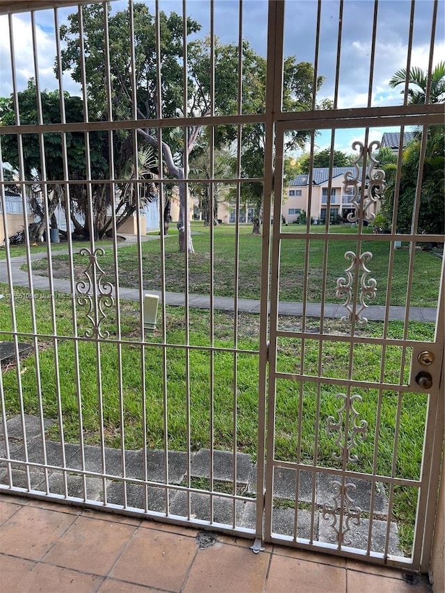 view of gate featuring a yard