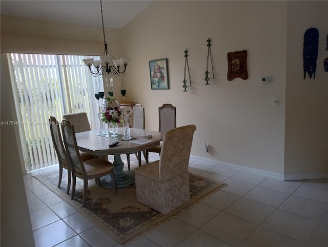 dining space with light tile patterned floors, baseboards, and a notable chandelier