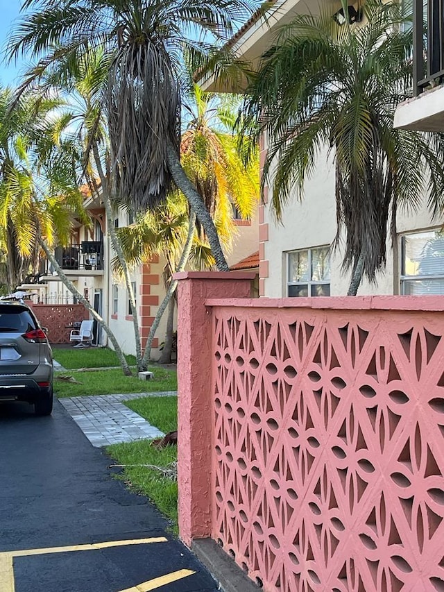 view of gate with a lawn