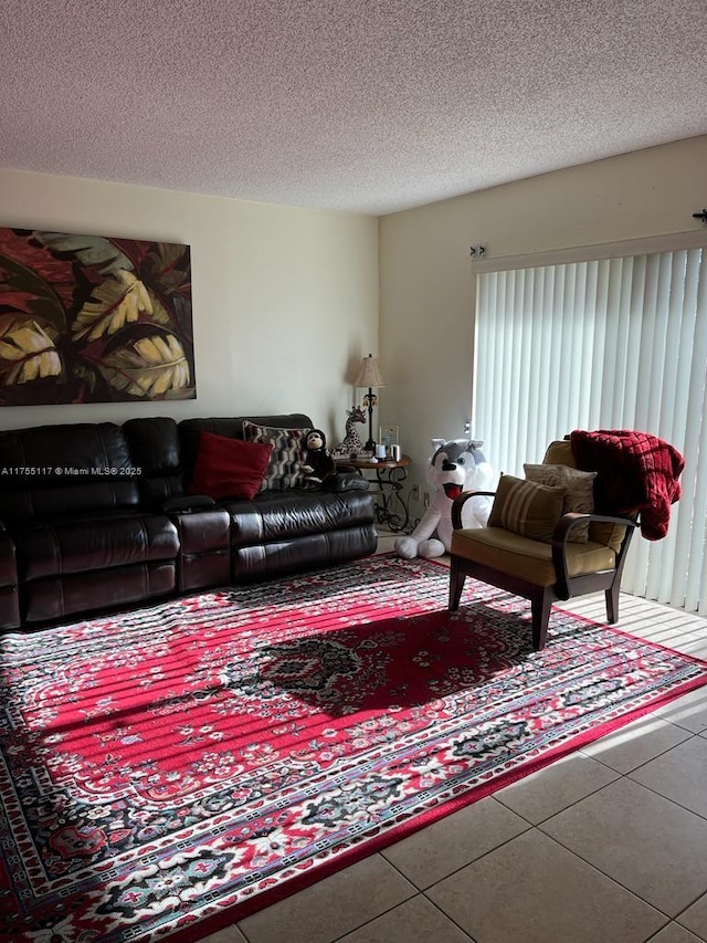 living room with a textured ceiling and tile patterned flooring