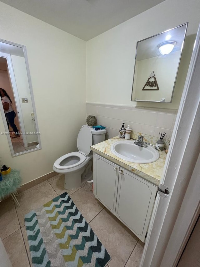 bathroom featuring backsplash, vanity, toilet, and tile patterned floors