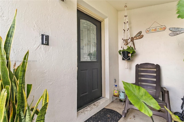 view of exterior entry with stucco siding