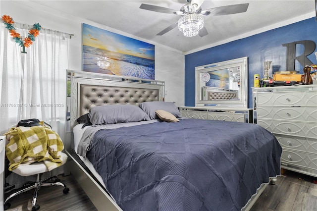 bedroom with a ceiling fan, crown molding, and wood finished floors