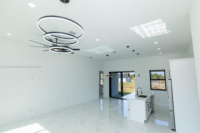 empty room featuring marble finish floor, a sink, and recessed lighting