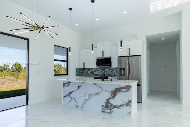 kitchen with marble finish floor, decorative backsplash, appliances with stainless steel finishes, white cabinets, and light stone countertops