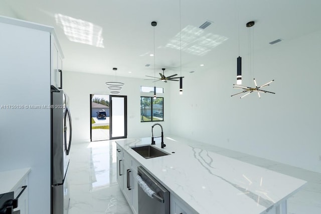 kitchen with a sink, visible vents, marble finish floor, appliances with stainless steel finishes, and hanging light fixtures