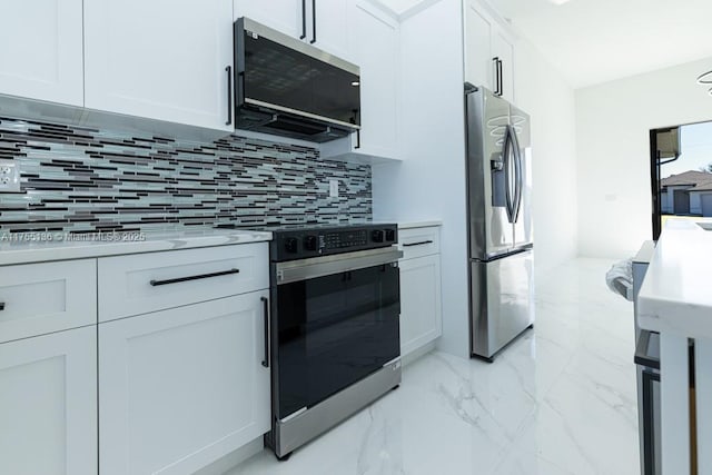 kitchen featuring stainless steel appliances, white cabinets, marble finish floor, light countertops, and tasteful backsplash