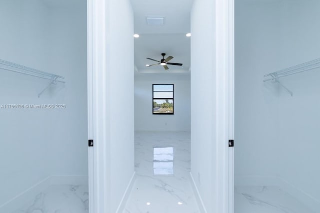 spacious closet with a ceiling fan, marble finish floor, and visible vents