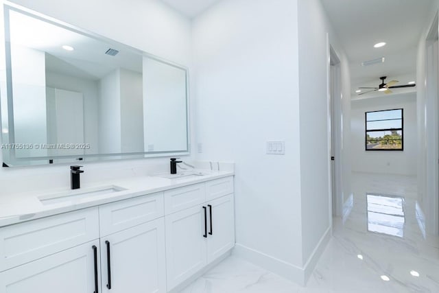 full bath with double vanity, visible vents, baseboards, marble finish floor, and a sink