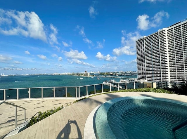 view of swimming pool featuring a water view and a view of city