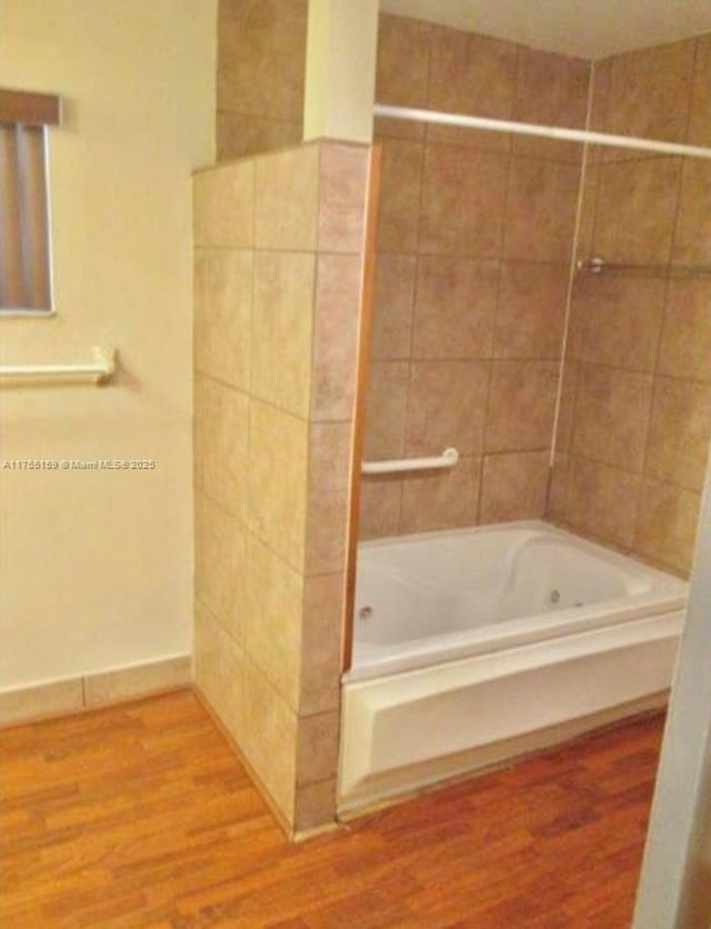 full bath with bathtub / shower combination and wood finished floors