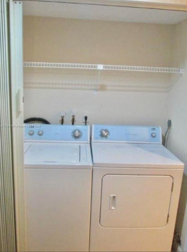 clothes washing area with laundry area and washer and clothes dryer