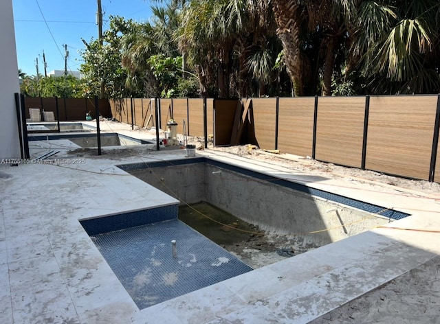 view of swimming pool featuring a fenced in pool, a patio area, and a fenced backyard