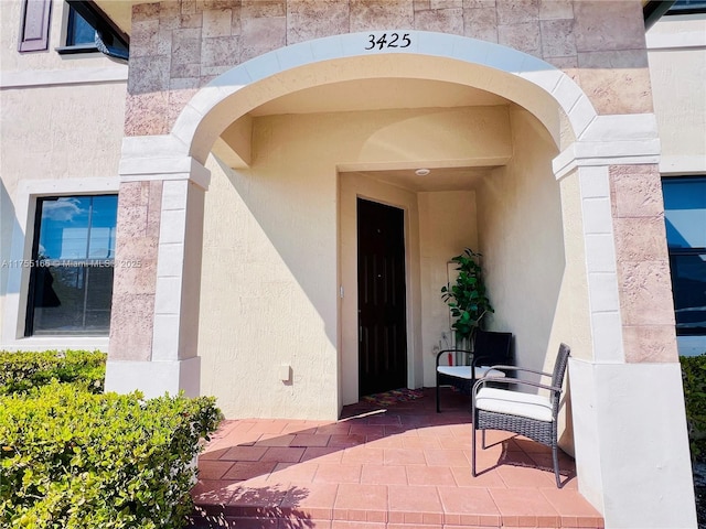 entrance to property with stucco siding