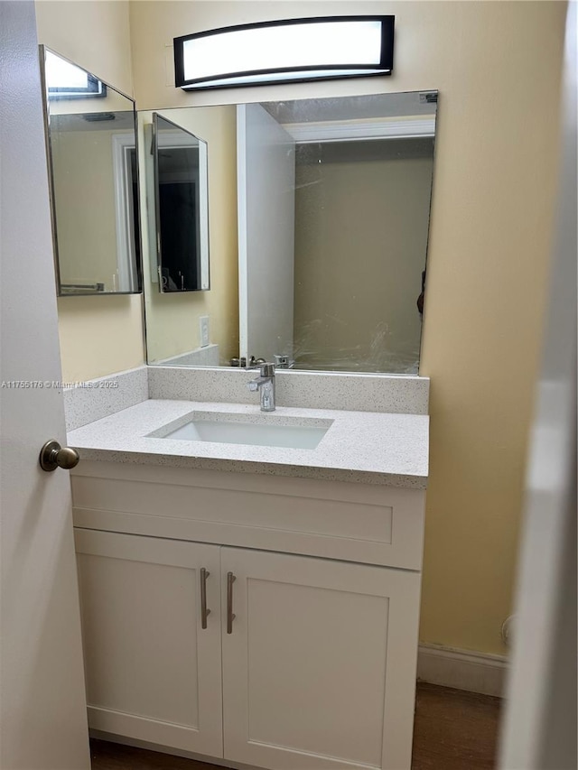 bathroom with vanity and baseboards