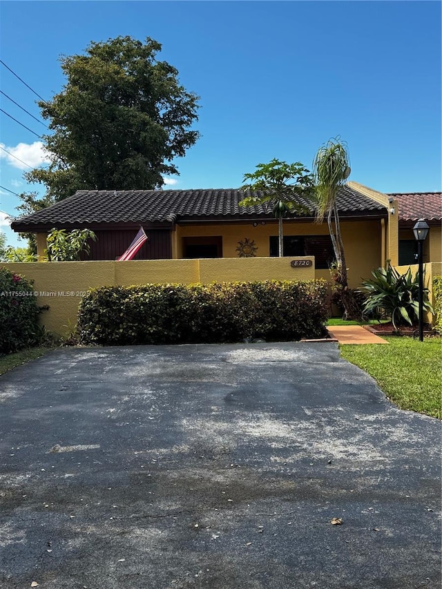 view of front of home featuring a tile roof and stucco siding