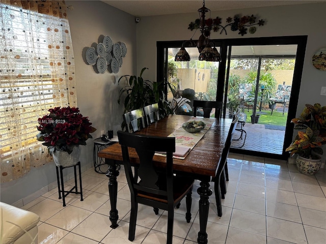 dining area with a wealth of natural light and light tile patterned flooring