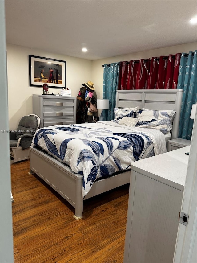 bedroom with wood finished floors and recessed lighting