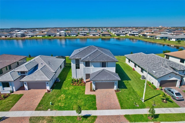 drone / aerial view with a residential view and a water view