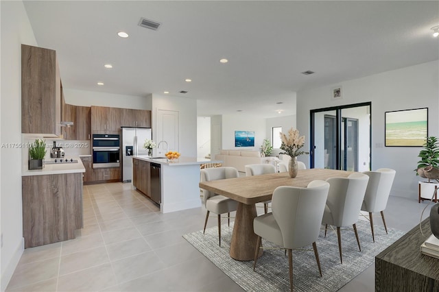 dining room featuring light tile patterned floors, visible vents, and recessed lighting