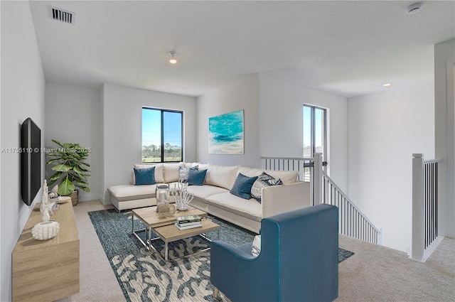 living room featuring visible vents and carpet flooring