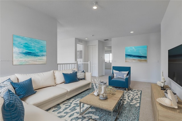 living area featuring light carpet, recessed lighting, visible vents, and baseboards