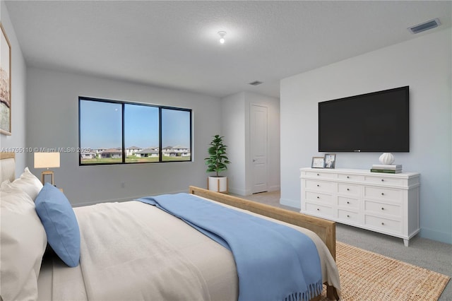 bedroom with carpet, visible vents, and baseboards