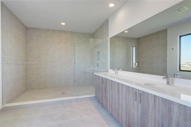 5007 Ofanto Ln, Ave Maria, FL 34142 - bathroom with double vanity, a sink, a walk in shower, tile patterned floors, and recessed lighting