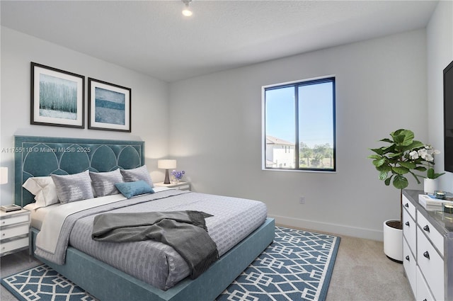 bedroom featuring carpet flooring and baseboards