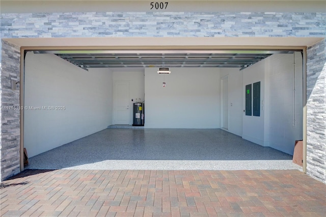 garage featuring water heater and a garage door opener