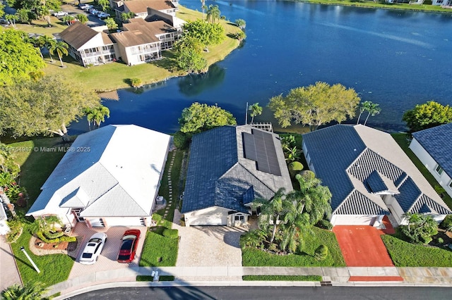 drone / aerial view with a water view and a residential view