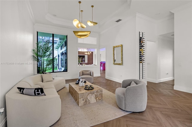 living room featuring baseboards, visible vents, and crown molding