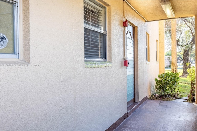 view of exterior entry with stucco siding