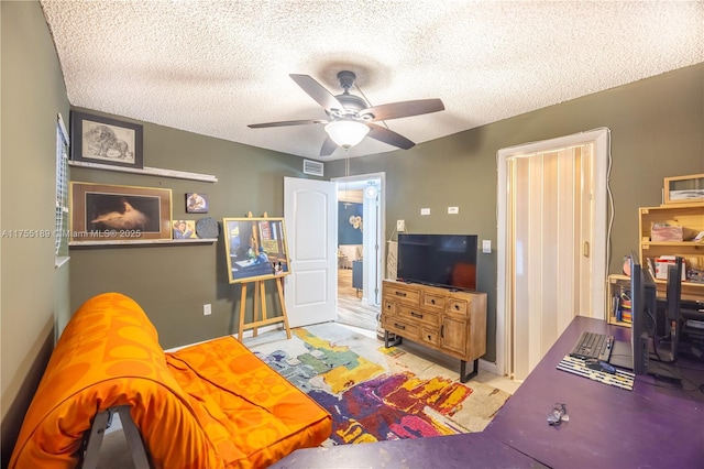 bedroom featuring visible vents, a textured ceiling, and ceiling fan