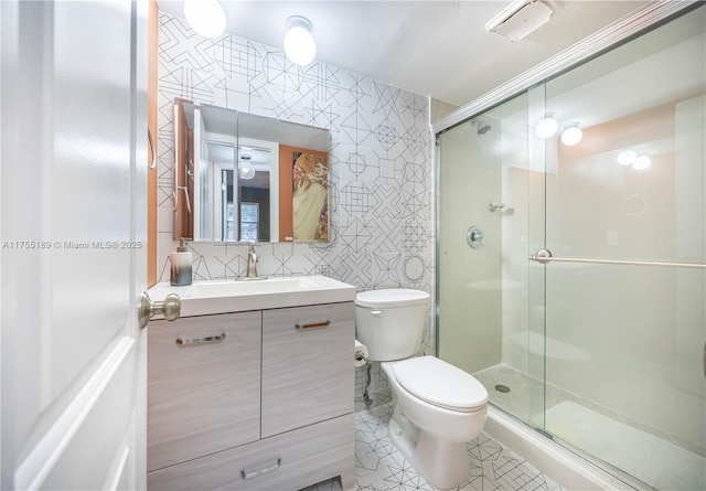 full bathroom featuring tile patterned floors, a shower stall, tile walls, and toilet