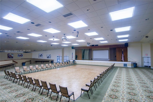miscellaneous room with visible vents, carpet flooring, and a paneled ceiling
