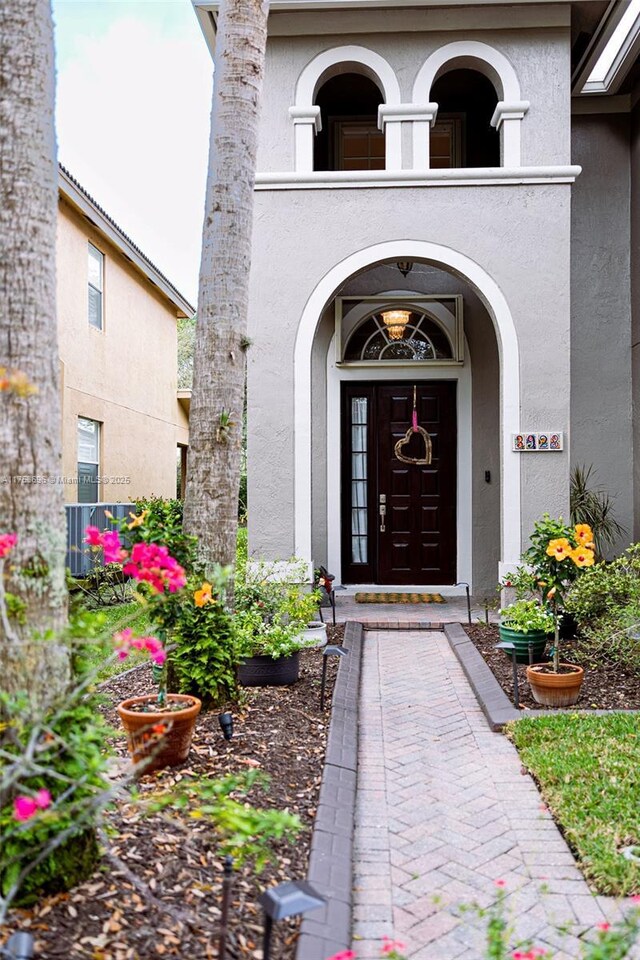 doorway to property featuring stucco siding