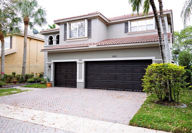 mediterranean / spanish-style home featuring decorative driveway and stucco siding