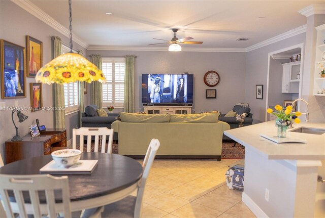 dining space with light tile patterned floors, visible vents, ceiling fan, and ornamental molding