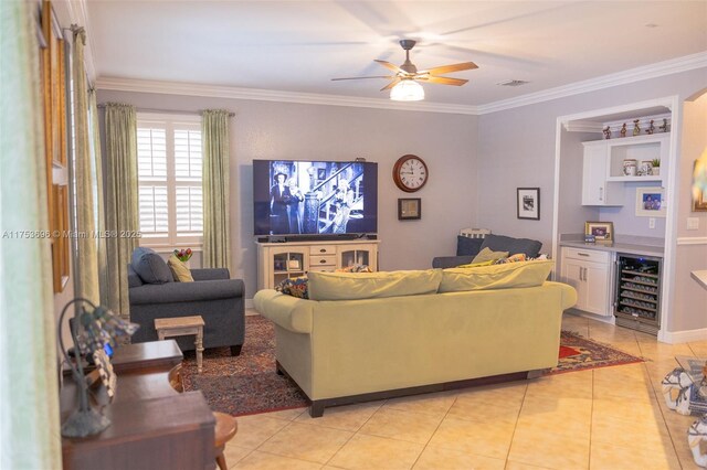 living area with wine cooler, light tile patterned floors, and ornamental molding