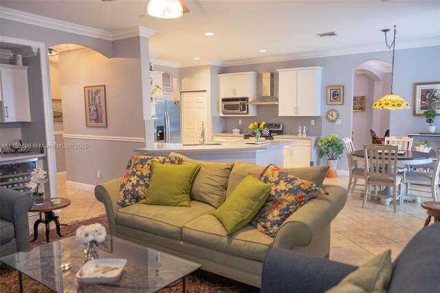 living room featuring arched walkways, visible vents, and light tile patterned flooring