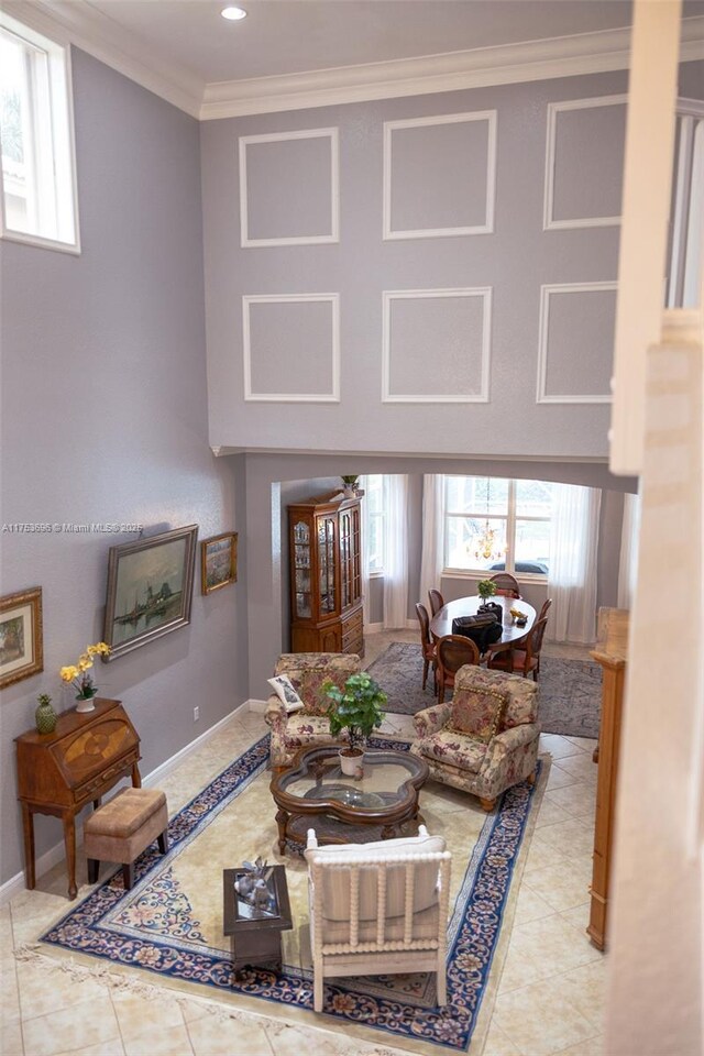 tiled living room featuring crown molding, recessed lighting, and baseboards