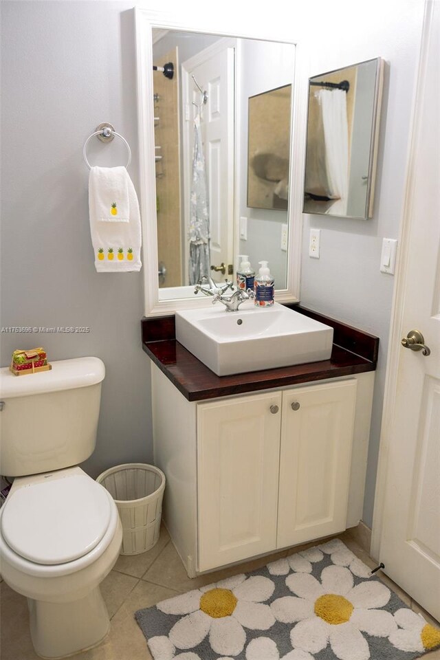 bathroom featuring tile patterned floors, toilet, and vanity