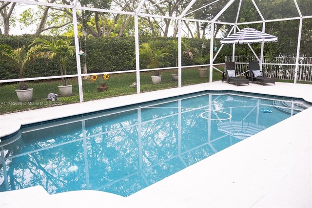 view of pool with glass enclosure, a patio, and a fenced in pool