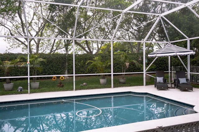 outdoor pool with a patio area and glass enclosure